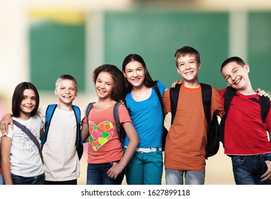 Portrait of happy schoolkids standing in line and looking at camera