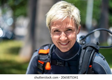 Portrait Of A Happy Scuba Diver With An Oxygen Tank And Wet Suit Already On, Spain