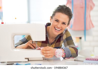 Portrait of happy seamstress sewing in studio - Powered by Shutterstock