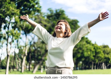 Portrait Of Happy Senior Adult Elderly Asia Women Smiling Standing And Stretch Her Arms Relax And Enjoy With Nature Fresh Air In The Park