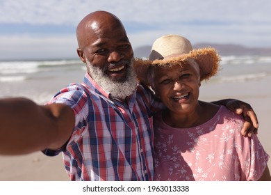 Portrait of happy senior african american couple taking a selfie at the beach. travel vacation retirement lifestyle concept