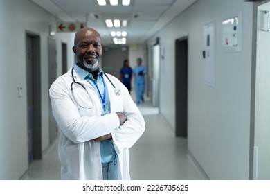 Portrait of happy senior african american male doctor in hospital corridor, copy space. Hospital, medical and healthcare services. - Powered by Shutterstock