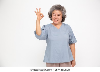 Portrait Of Happy Senior Asian Woman Gesture Or Showing Hand Ok And Looking At Camera Isolated On White Background, Older Female Feeling Positive And Enjoy Concept