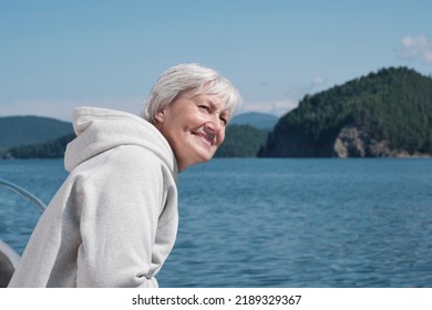 Portrait Of Happy Senior Caucasian Woman With Gray Hair Traveling On Boat On Lake Baikal, Russia. Travel, Elderly People Concept