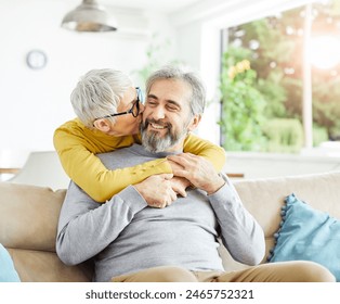 Portrait of a happy senior couple embracing hugging and having fun at home - Powered by Shutterstock