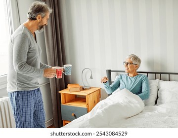 Portrait of a happy senior couple embracing each other on bed, elderly couple at home - Powered by Shutterstock