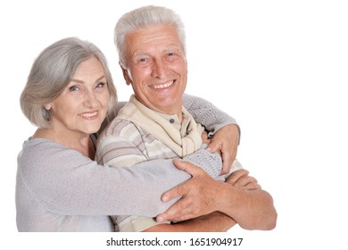 Portrait Of Happy Senior Couple Hugging Isolated On White Background