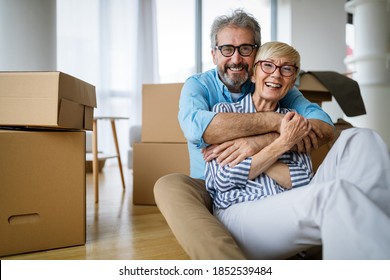 Portrait of happy senior couple in love moving in new home