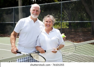 Portrait of a happy senior couple on the tennis courts. - Powered by Shutterstock