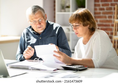 Portrait Of Happy Senior Couple Reading Letter Together