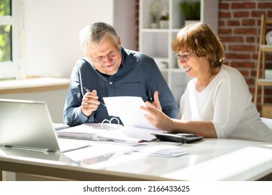 Portrait Of Happy Senior Couple Reading Letter Together