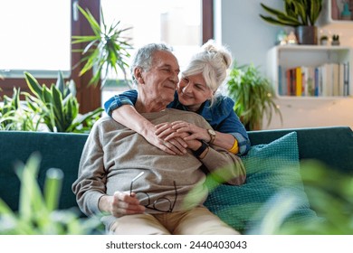 Portrait of a happy senior couple sitting on sofa at home
 - Powered by Shutterstock