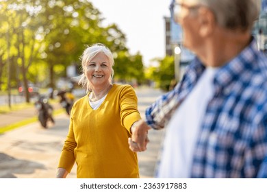 Portrait of happy senior couple standing in city street on a sunny day
 - Powered by Shutterstock