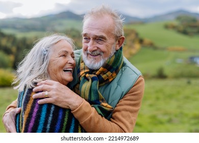 Portrait of happy senior couple walking in autumn meadow. - Powered by Shutterstock