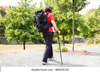 Portrait Of A Happy Senior Female Hiker With Hiking Pole