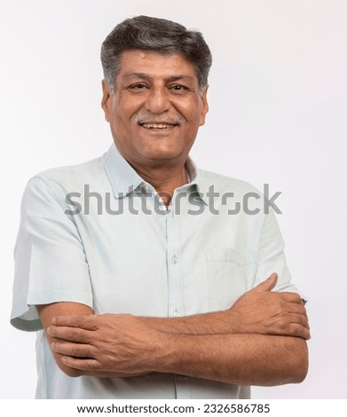 Portrait of happy senior man with arms crossed