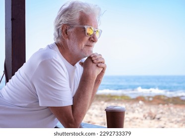 Portrait of Happy Senior Man at the Beach Looking Away - Vacation Retirement Lifestyle concept at Sea - Smiling Elderly Grandfather Enjoying Freedom and Good Time - Powered by Shutterstock