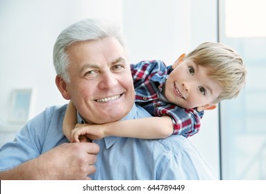 Portrait Of Happy Senior Man With Grandson