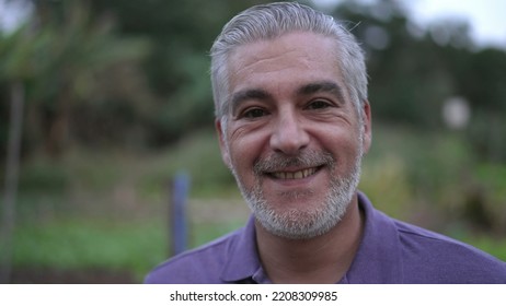 Portrait Of A Happy Senior Man Smiling At Camera In The Evening. Older Person With Gray Hair