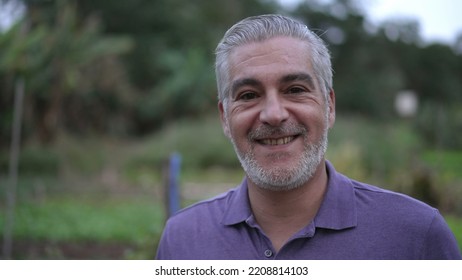 Portrait Of A Happy Senior Man Smiling At Camera In The Evening. Older Person With Gray Hair