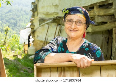 Portrait Of A Happy Senior Muslim Woman With Eyeglass Carrying A Wooden Box In Outdoor Area