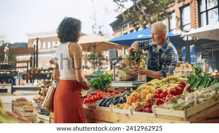 Portrait of a Happy Senior Street Vendor Packing a Paper Bag with Fresh Organic Vegetables for a Female Shopper. Multiethnic Woman Buying Sustainable Local Produce From a Farm Market Stand