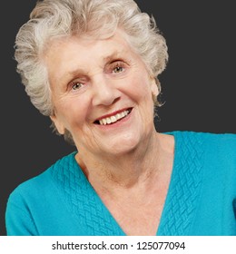 Portrait of happy senior woman isolated on black background
