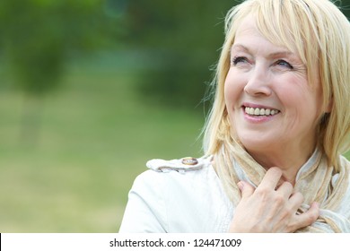 Portrait Of Happy Senior Woman In Park