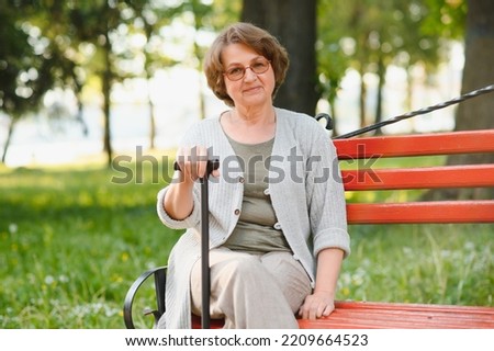 Similar – Smiling senior woman in wheelchair