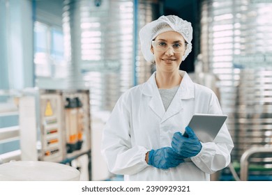 Portrait happy senior women worker in drinking water plant clean hygiene uniform stading smiling. - Powered by Shutterstock