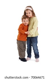 Portrait Of Happy Siblings Hugging Each Other, Smiling At Camera.?