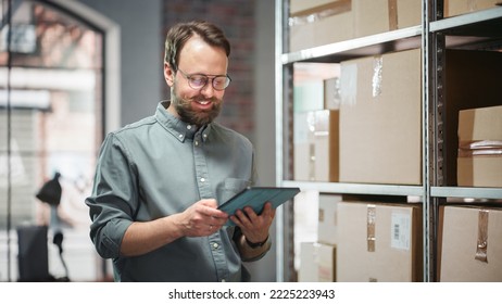 Portrait of a Happy Small Warehouse Employee Checking Inventory, Using Tablet. Handsome Man with Moustache Smiling in a Storeroom with Parcels and Online Purchased Orders Ready for Shipment. - Powered by Shutterstock