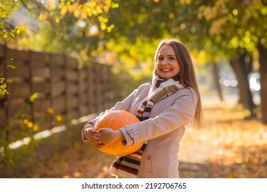 Portrait Of Happy Smile Woman With Pumpkins In Hand.