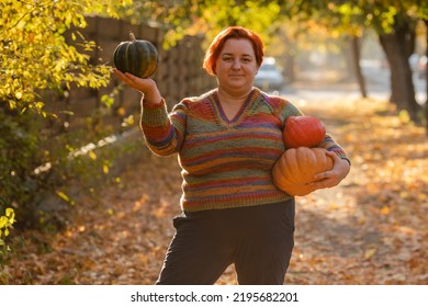 Portrait Of Happy Smile Woman With Pumpkins In Hand.