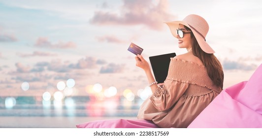 Portrait of happy smile young adult asian woman hand using credit card for cashless payment online for shopping or travel. Beach with sky banner background with copy space. - Powered by Shutterstock