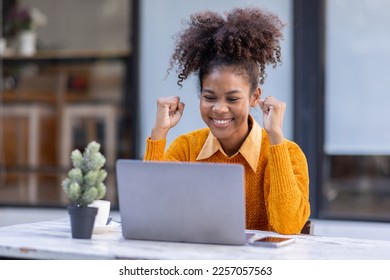 Portrait of Happy smiling african american businesswoman, adorable girl using laptop browsing web drinking coffee in cafe restaurant outdoors - Powered by Shutterstock