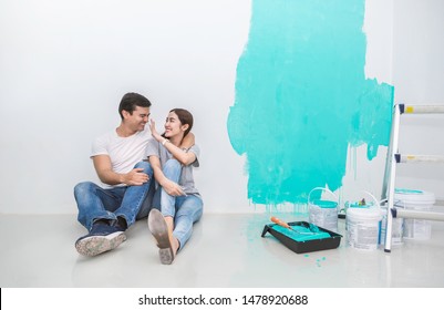 Portrait Of Happy Smiling Asian Couple Renovating Painting Wall House. Mother Father Repairing Paint Wall At Home. Man And Woman Together Love Lifestyle Concept With Copy Space.