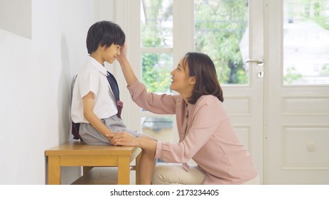 Portrait Of Happy Smiling Asian Family Talking Together. A Student Prepaing To Go To School At Home Or House  In Family Relationship. Love Of Mother, And Son. People Lifestyle.