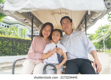 Portrait Of Happy Smiling Asian Family Living Together On Golf Cart, In Family Relationship On Vacation. Love Of Father, Mother, And Son. People Lifestyle.