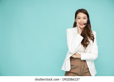 Portrait of happy smiling asian woman customer support phone operator isolated on green background, Call center or Customer service concept - Powered by Shutterstock