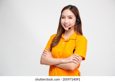 Portrait Of Happy Smiling Asian Woman Telemarketing Operator In Orange Delivery Uniform With Headphone Isolated On White Background, Call Center Or Customer Service Concept