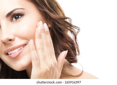 Portrait of happy smiling beautiful young woman touching skin or applying cream, isolated over white background