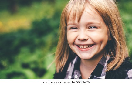 Portrait Of A Happy Smiling Child Girl. Laughing Child. Expressive Facial Expressions. Black And White Image. Space For Text.