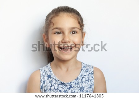 Portrait of a happy smiling child girl. Laughing child. Expressive facial expressions.