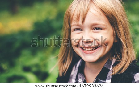 Portrait of a happy smiling child girl. Laughing child. Expressive facial expressions. Black and white image. Space for text.