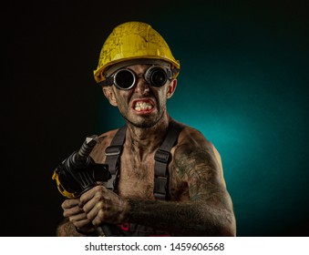 Portrait Of Happy Smiling Coal Miner With His Arms Crossed Against A Dark Background