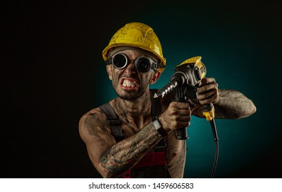 Portrait Of Happy Smiling Coal Miner With His Arms Crossed Against A Dark Background