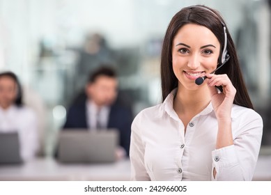 Portrait of happy smiling female customer support phone operator at workplace. - Shutterstock ID 242966005