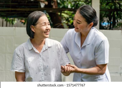 Portrait of happy smiling nurse helping mature elderly  standing and walking in a nursing house. Nursing home, Hospital, health, care, nurse Concept.  - Shutterstock ID 1571477767
