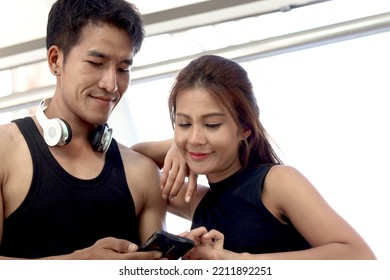 Portrait Of Happy Smiling Partner Buddy Runner Man And Woman Lover Using Mobile Phone, Exercise Run Outdoor, Partner Buddy Runner Jogger Athlete Training And Doing Workout In Downtown City.